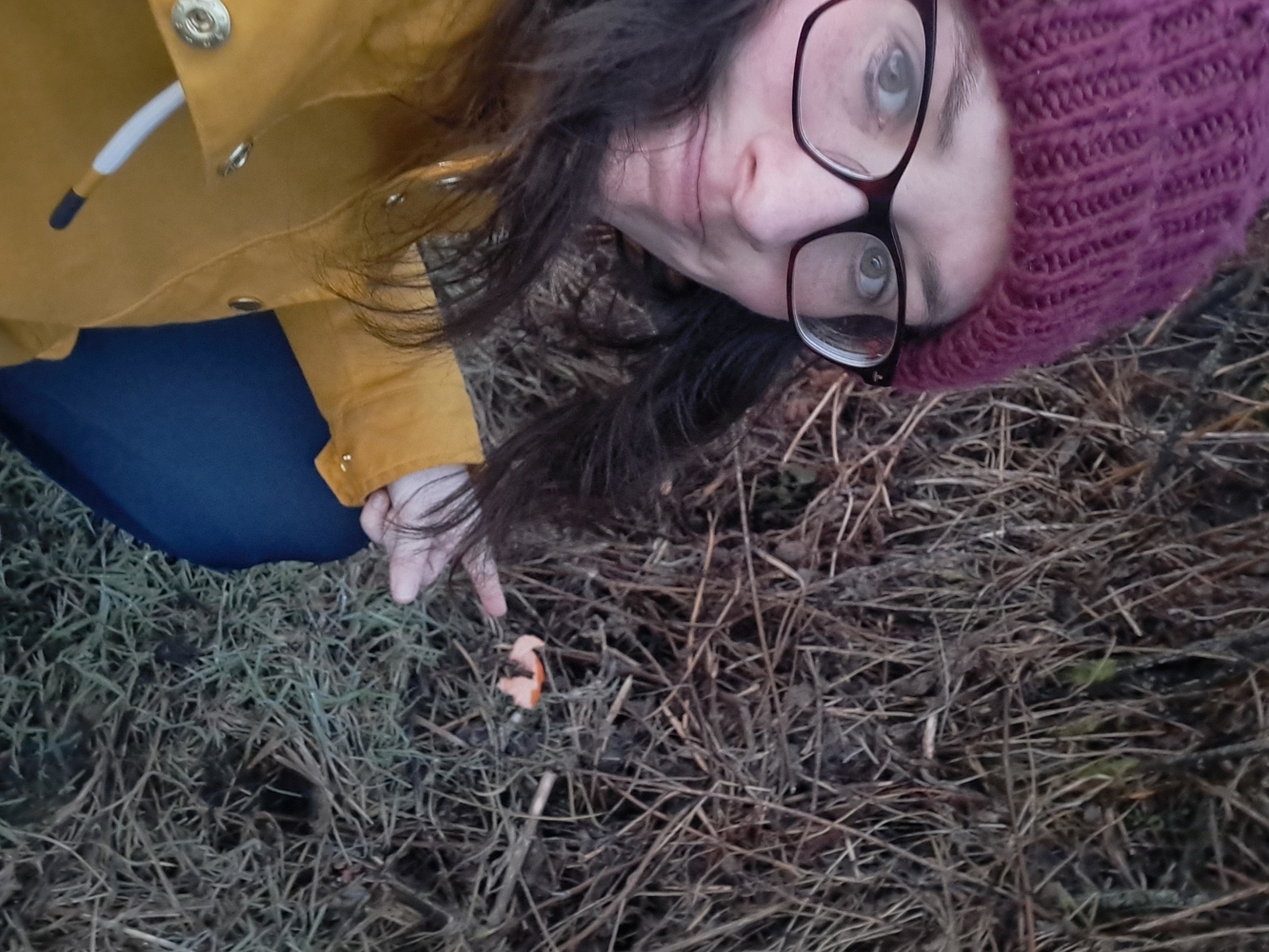 Heather pointing to an apple core in a hedge