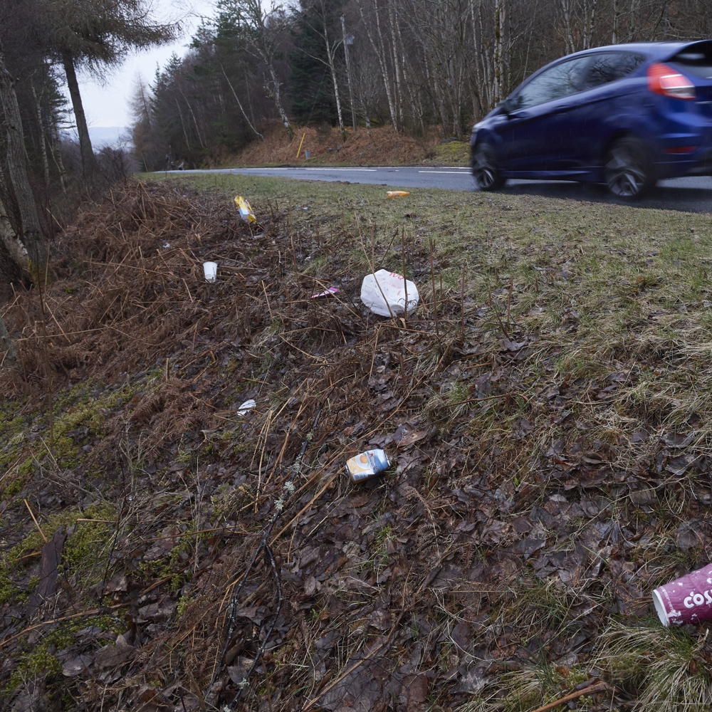 Roadside litter with car driving past