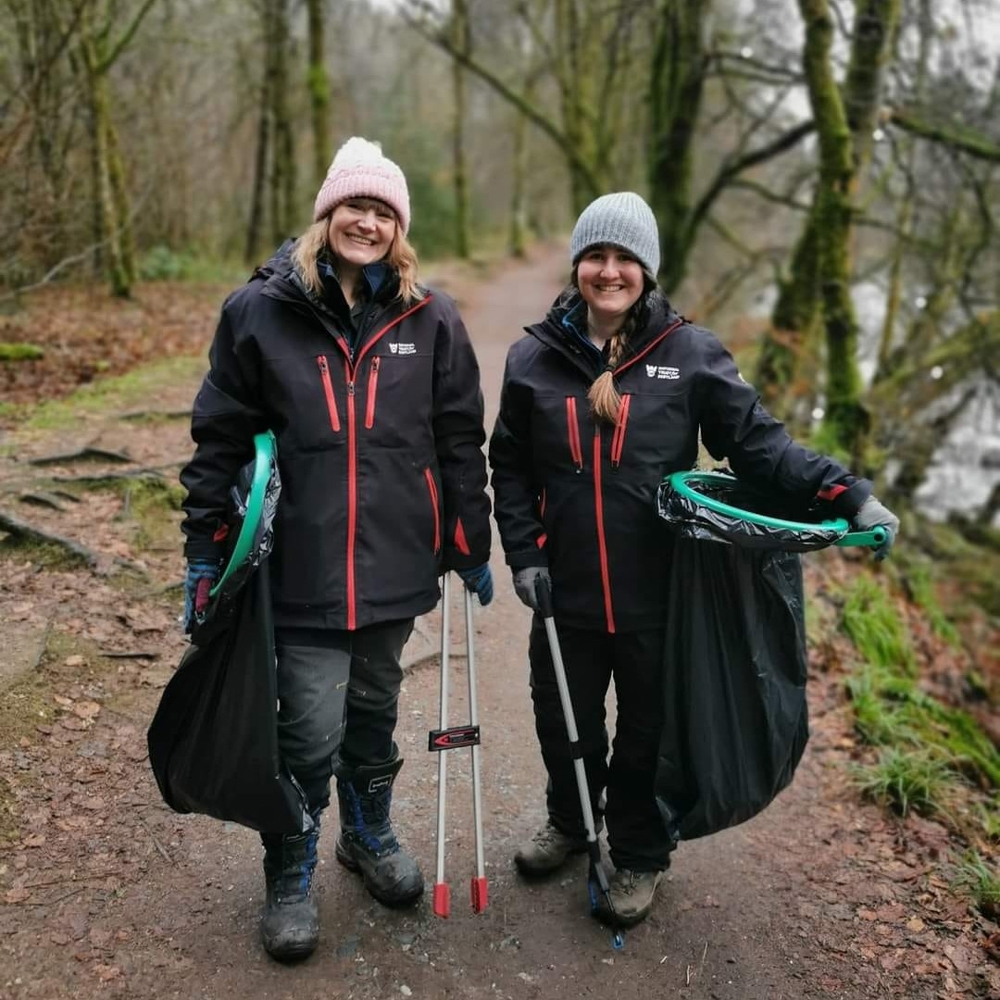 Two woman with litter picking equipment