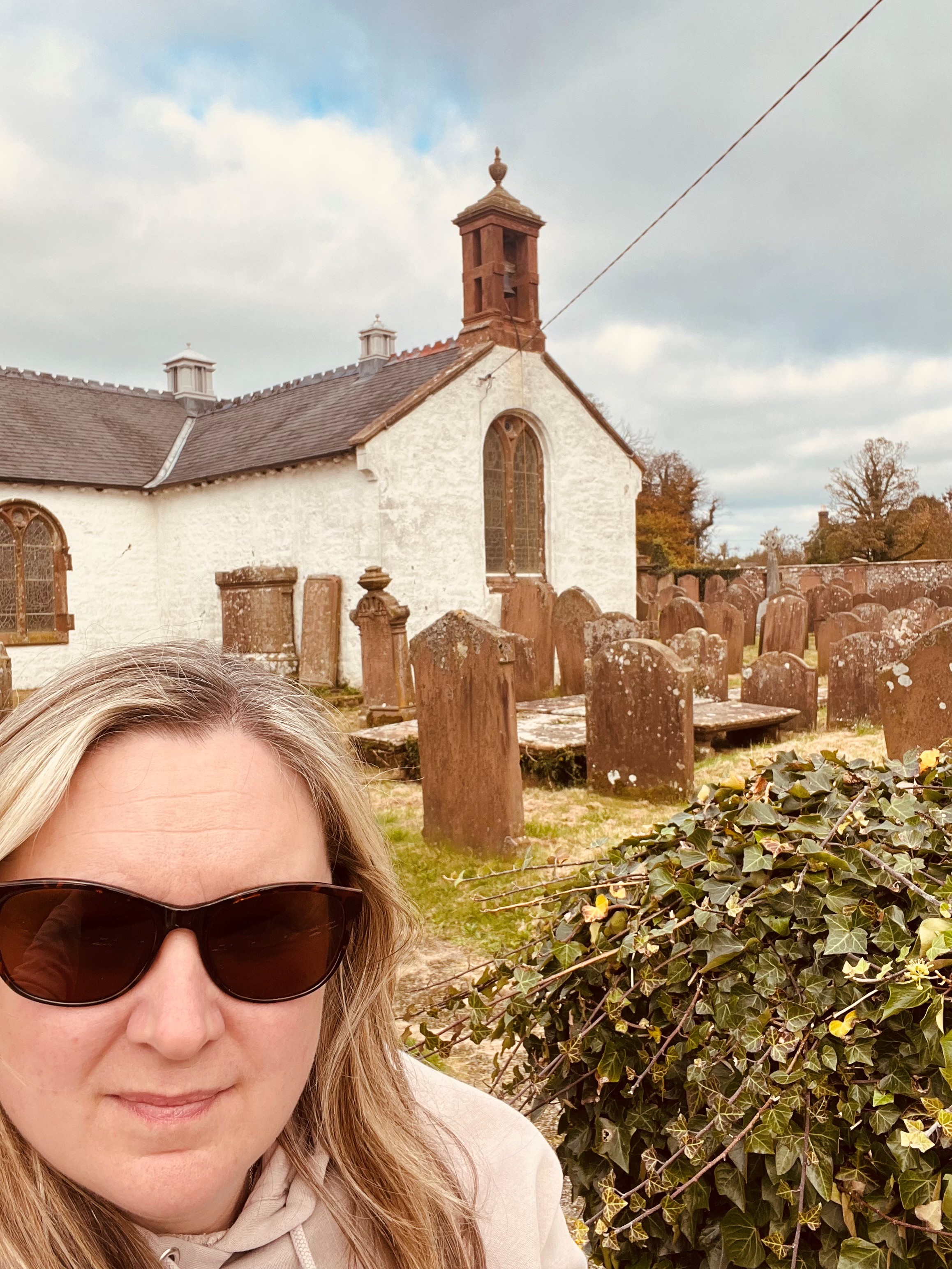Joanne in front of Ruthwell Church