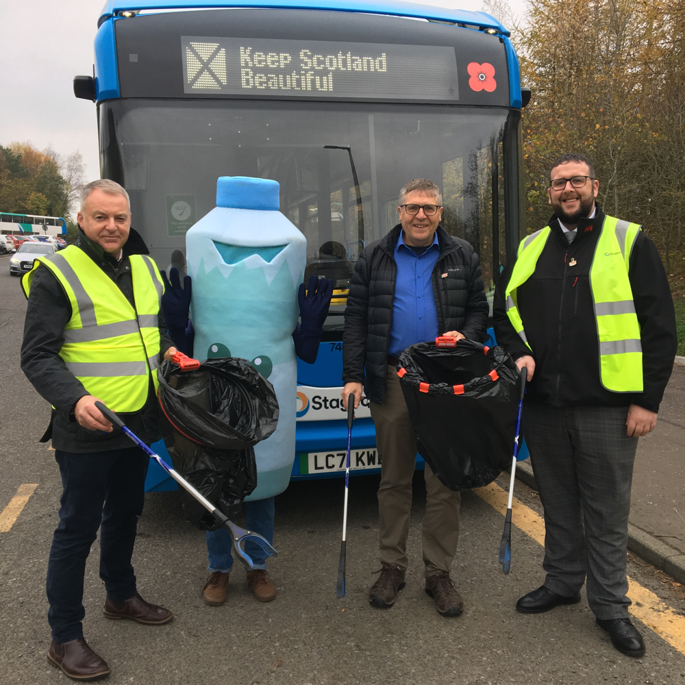 People and a litter costume standing in front of a bus branded by Keep Scotland Beautiful